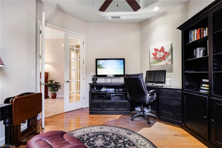 Office space with French Doors, Tray ceiling with fan, Plantation Shutters and Real Hardwood floors