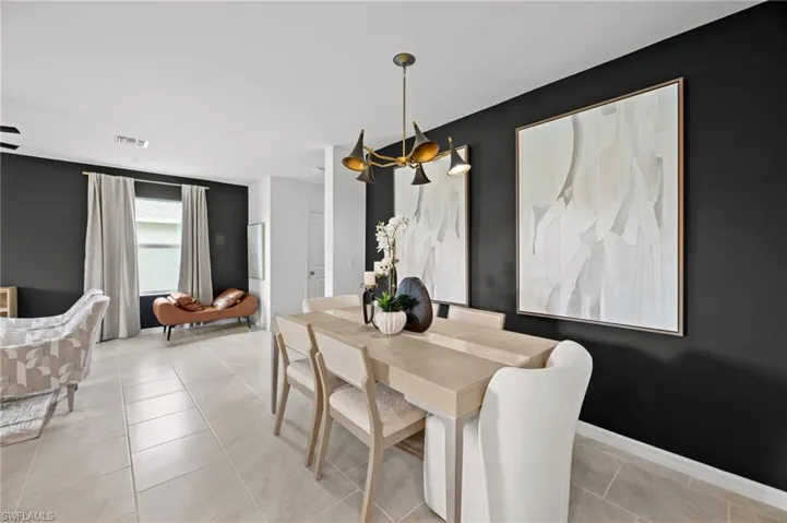 Dining room with visible vents, baseboards, a notable chandelier, and light tile patterned floors