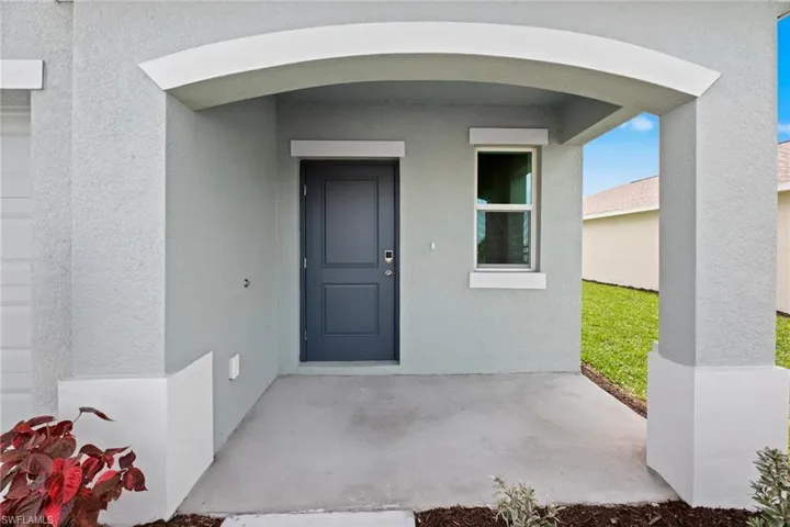 View of exterior entry with stucco siding