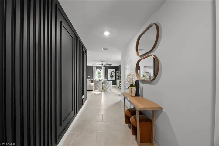 Corridor with visible vents and light tile patterned flooring