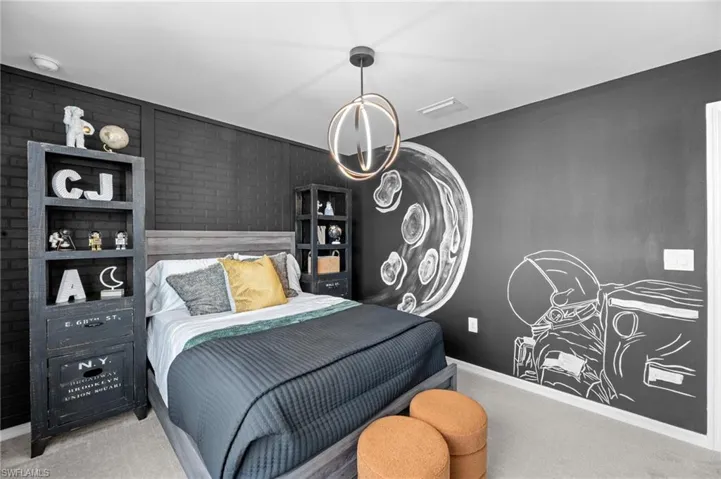 Carpeted bedroom with baseboards and visible vents