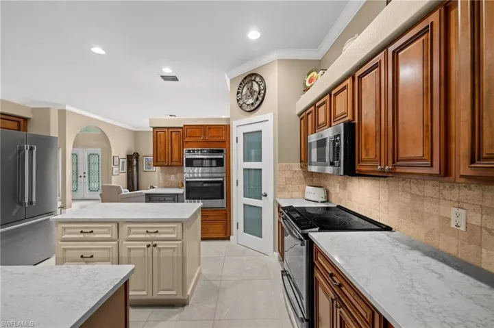 Updated kitchen features rich wood cabinetry and new countertops