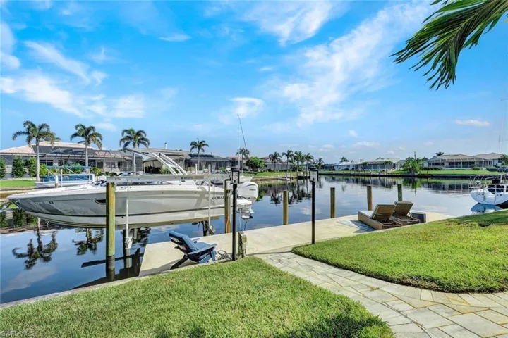 Dock featuring a water view and a yard