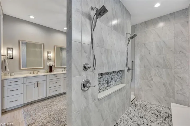Full bathroom featuring vanity, a walk in shower, and recessed lighting
