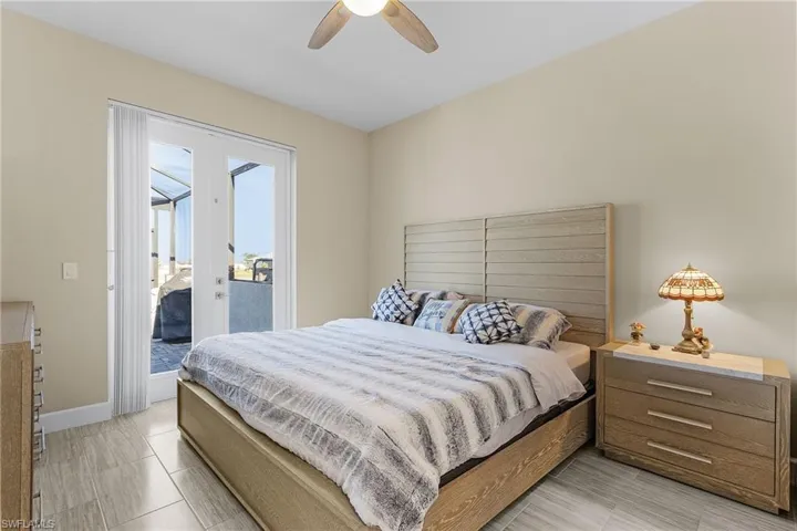 Bedroom featuring access to exterior and ceiling fan