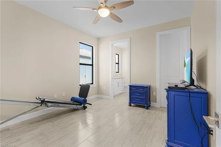 Exercise area featuring ceiling fan and light wood-type flooring