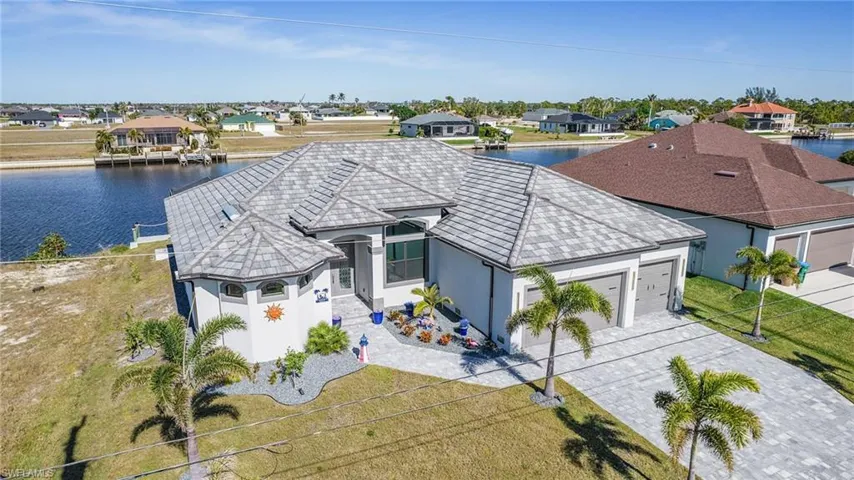 View of front of home featuring a garage and a water view