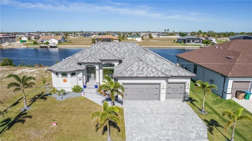 View of front of property featuring a water view and a garage