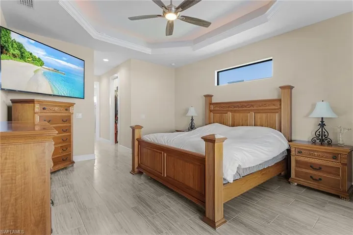Bedroom featuring a tray ceiling and ceiling fan