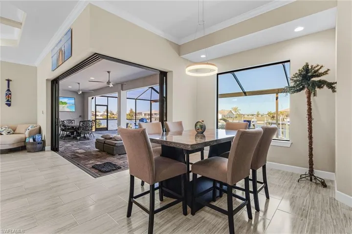 Dining space featuring ornamental molding and ceiling fan
