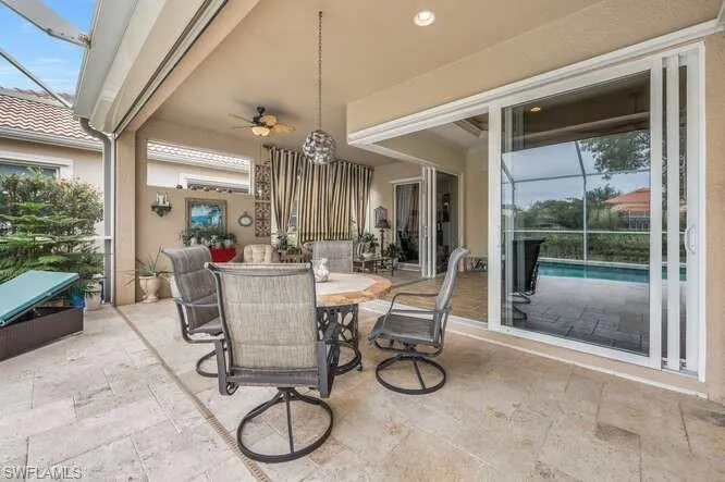 View of patio / terrace featuring ceiling fan and a lanai