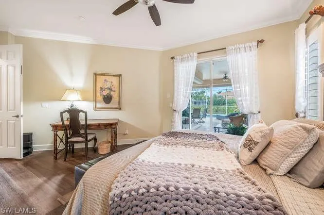 Bedroom featuring ceiling fan, access to exterior, dark hardwood / wood-style floors, and crown molding