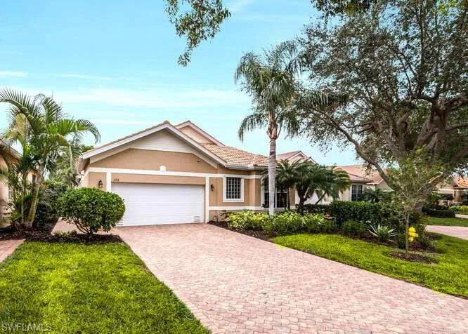 View of front of property featuring a garage and a front yard