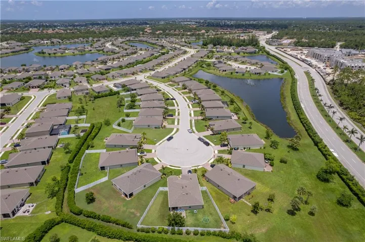 Aerial view of property's location with a large body of water and nearby suburban area
