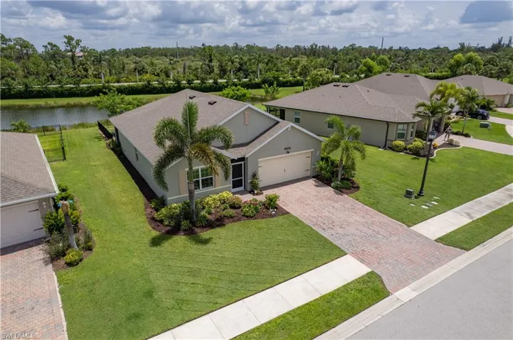 Aerial view of property and surrounding area featuring a large body of water