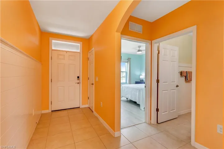 Foyer entrance featuring arched walkways and light tile patterned floors