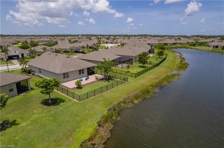 Aerial perspective of suburban area featuring a nearby body of water