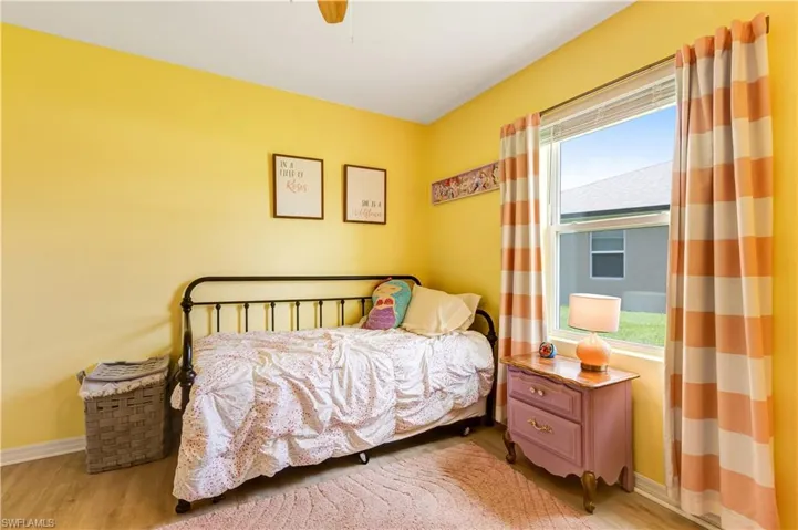 Bedroom featuring wood finished floors and ceiling fan