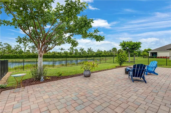 Fenced backyard with a patio and a water view