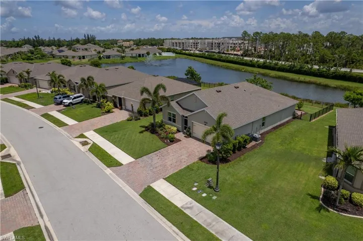 Aerial perspective of suburban area featuring a large body of water