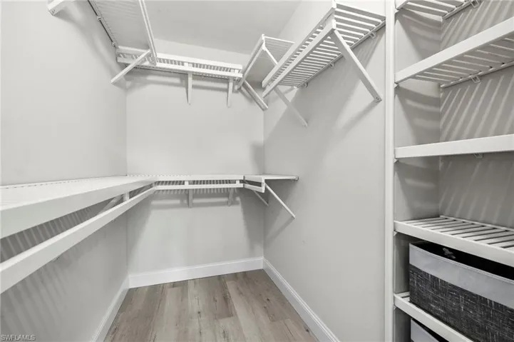 Spacious closet with wood finished floors