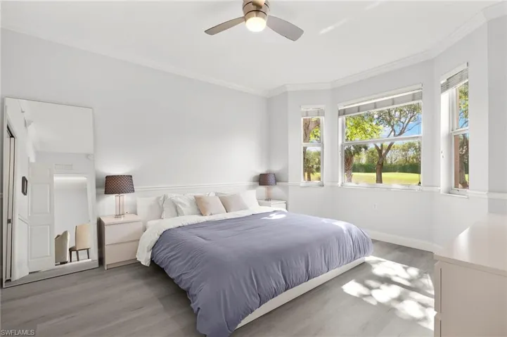 Bedroom featuring crown molding, baseboards, a ceiling fan, and light wood-style floors