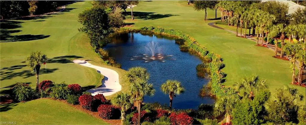 Drone / aerial view with a water view and golf course view
