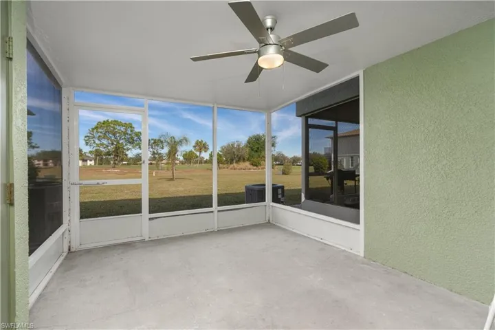Unfurnished sunroom with ceiling fan