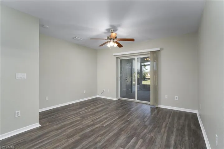 Spare room with ceiling fan and dark hardwood / wood-style flooring