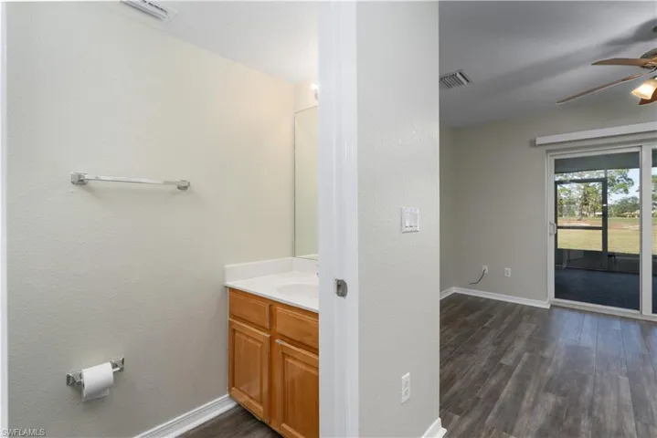 Bathroom featuring wood-type flooring, vanity, and ceiling fan