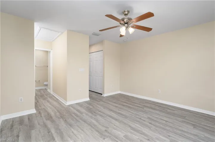 Empty room with light hardwood / wood-style flooring and ceiling fan
