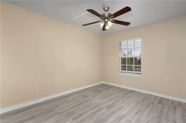 Spare room featuring ceiling fan and light wood-type flooring