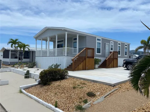 Manufactured / mobile home featuring stairs and covered porch