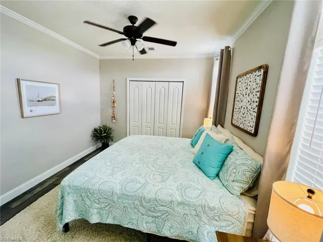 Bedroom (Master) ornamental molding, a closet, and ceiling fan