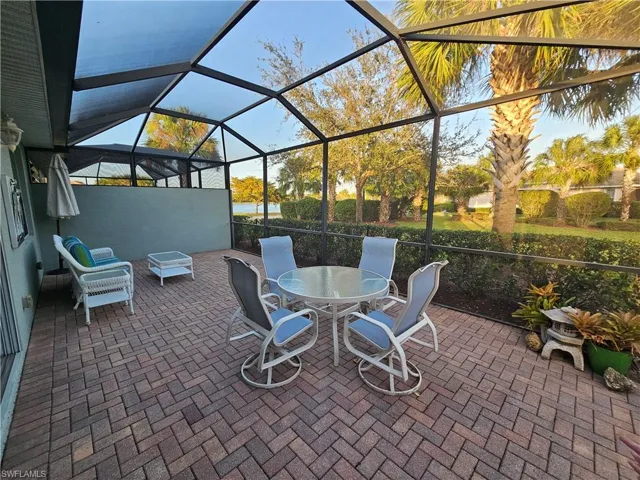 View of patio featuring a lanai