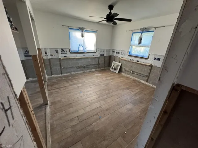 Kitchen with wood-type flooring and ceiling fan