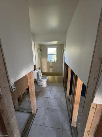 Bathroom featuring toilet and tile patterned floors