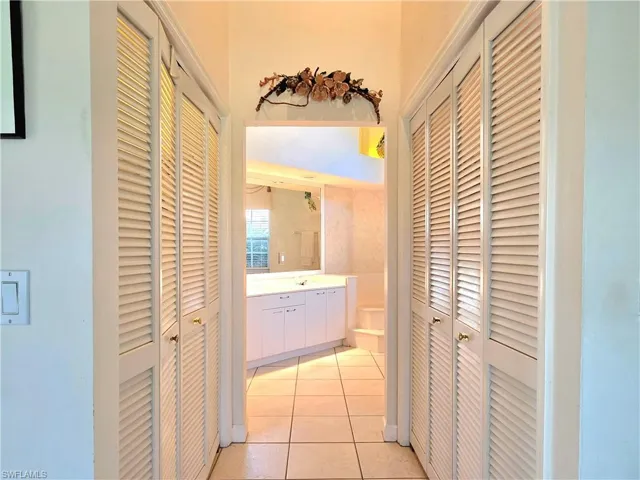Full bathroom featuring double vanity, a garden tub, and plenty of natural light