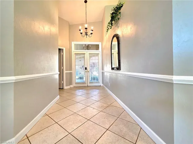 Corridor with light tile patterned floors