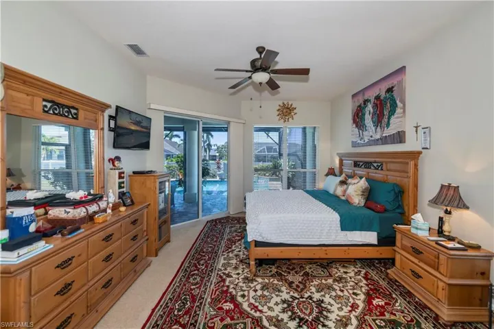 Spacious Master Bedroom with slider to pool area