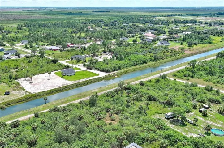 Aerial view of a nearby body of water and a tree filled landscape