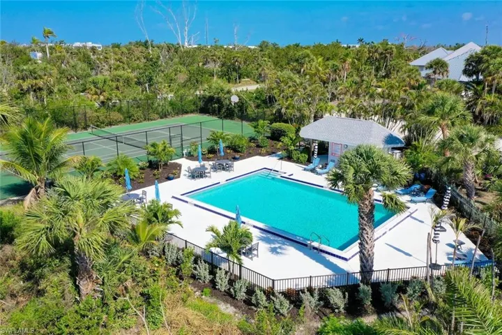 Community pool featuring fence and a patio