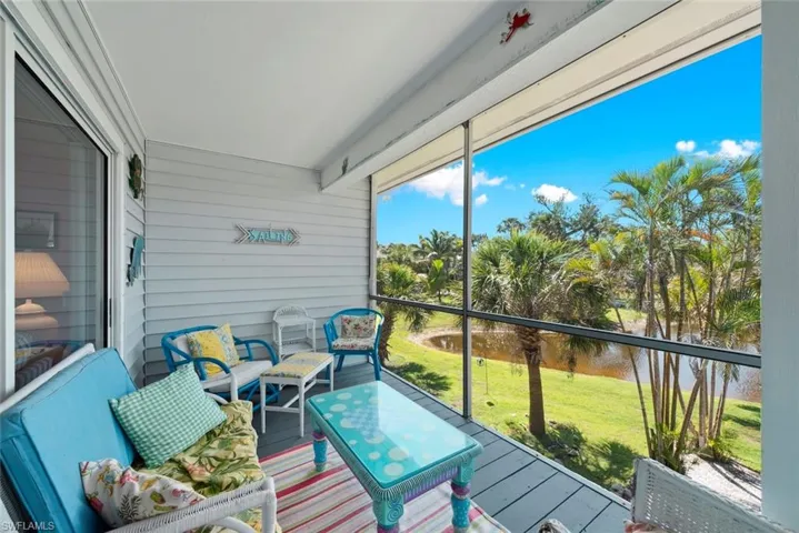 Sunroom / solarium featuring a water view