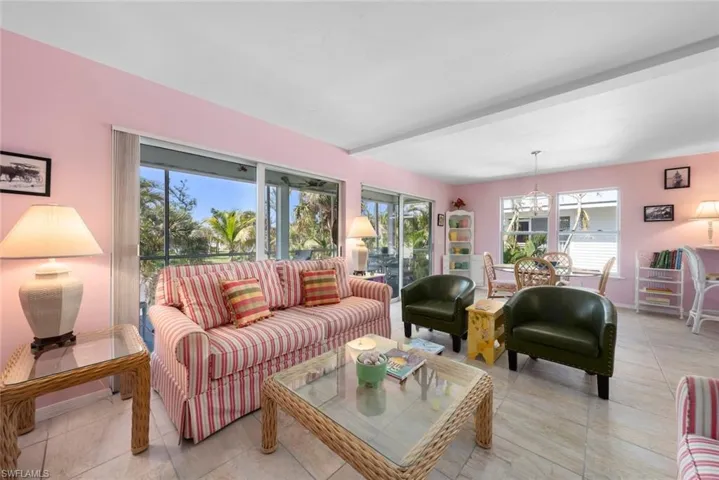Living area featuring a chandelier, light tile patterned floors, and plenty of natural light
