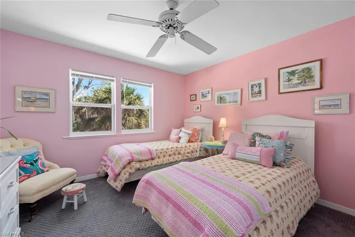 Bedroom featuring baseboards, a ceiling fan, and carpet flooring