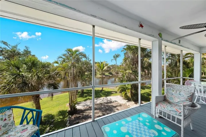 Sunroom featuring a water view and a ceiling fan