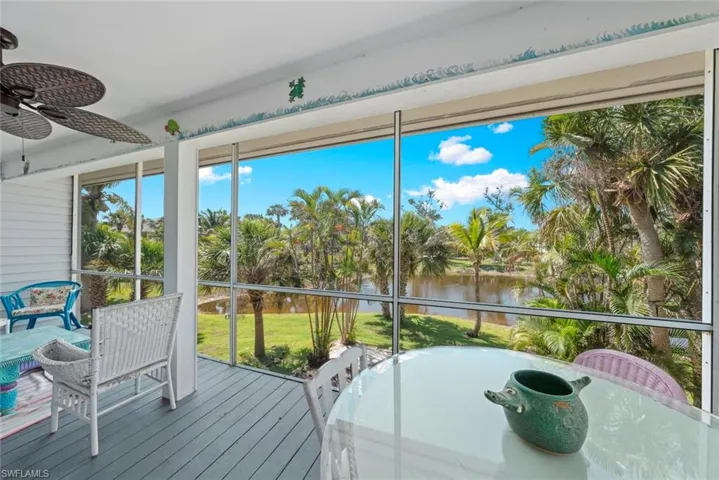 Sunroom / solarium featuring a water view and ceiling fan