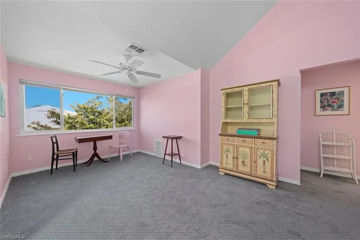 Living area featuring carpet, baseboards, a ceiling fan, and visible vents
