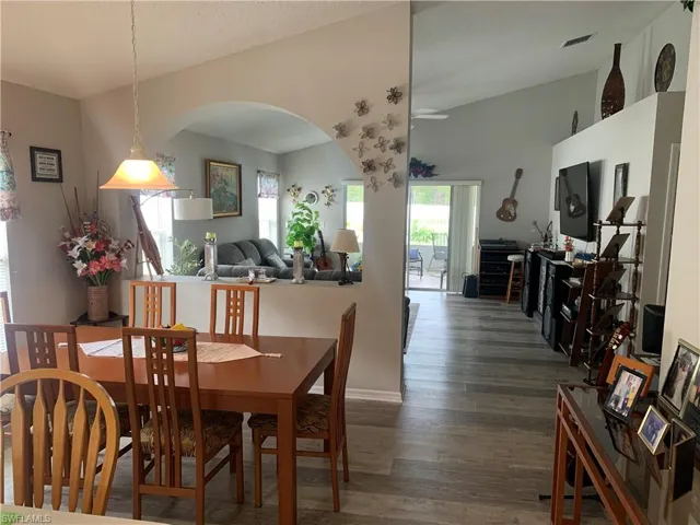 Dining area with dark hardwood / wood-style floors