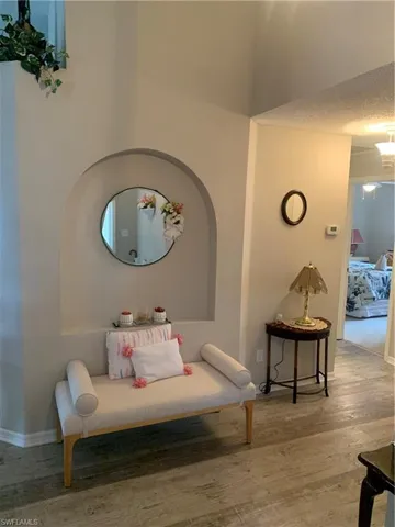 Living area with hardwood / wood-style flooring and a textured ceiling
